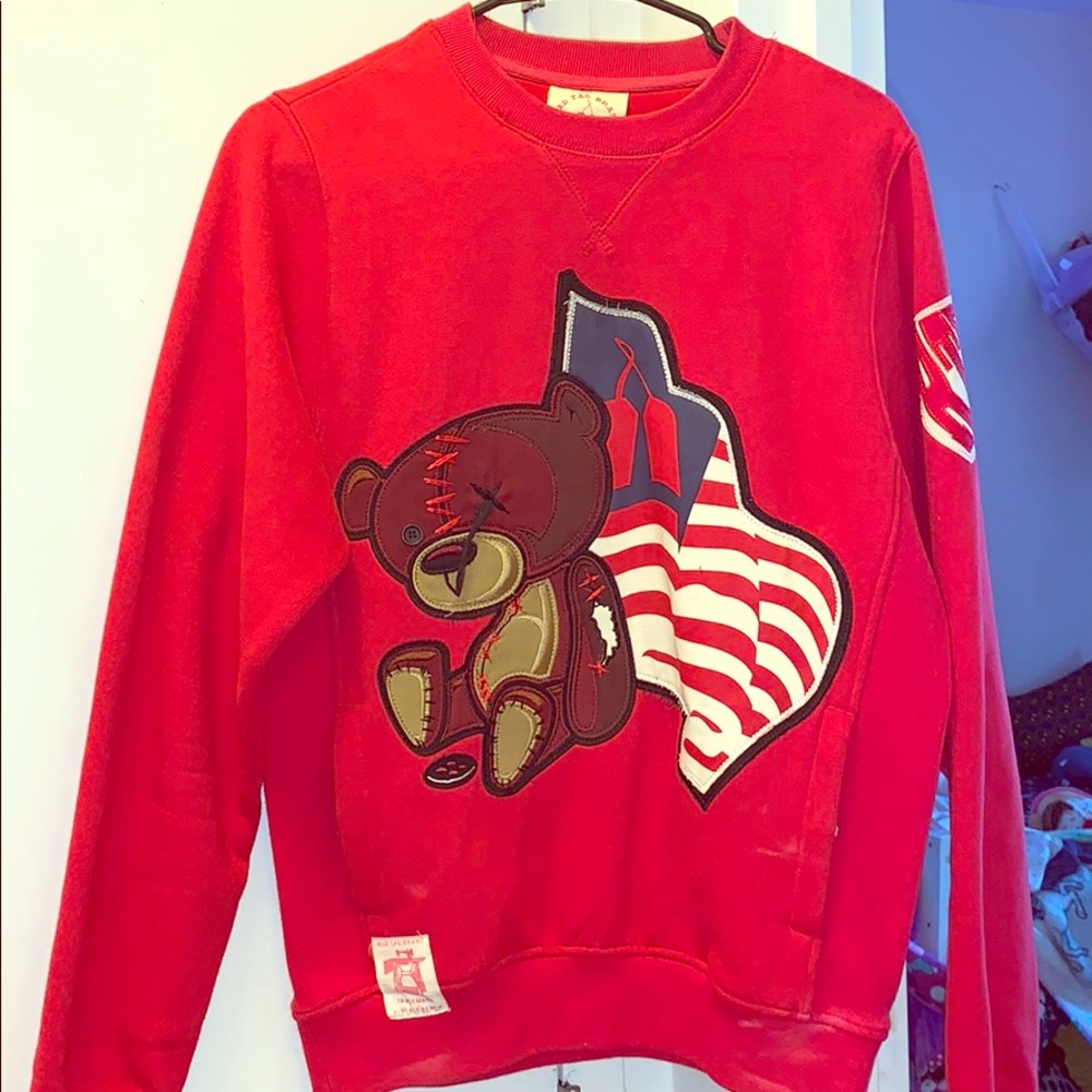 A red designer sweater